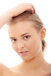 Close-up portrait of a beautiful young woman over white background