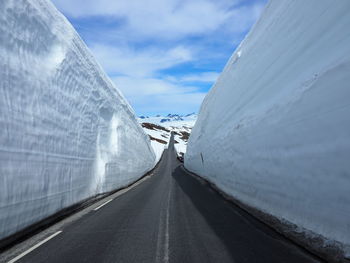 Road amidst snow against sky