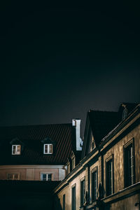 Low angle view of buildings against sky at night