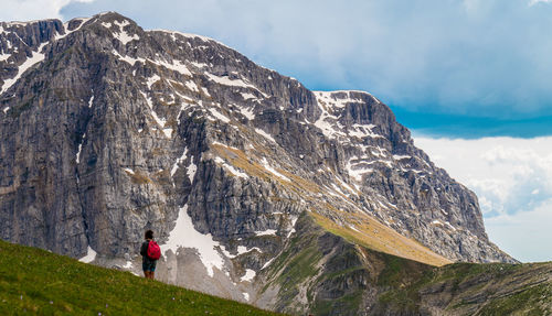 Rear view of woman standing on mountain during winter