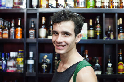 Portrait of smiling young man in liquor store