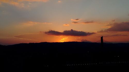 Silhouette landscape against sky during sunset