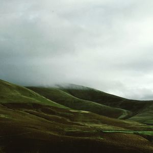 Scenic view of landscape against cloudy sky