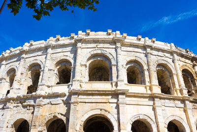 Low angle view of historical building against blue sky