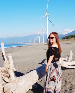 Full length of woman on beach against sky