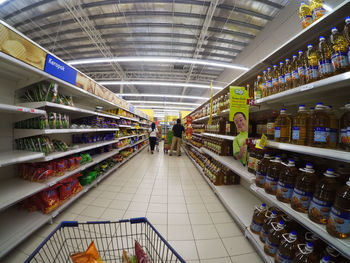 Low angle view of people walking in illuminated store