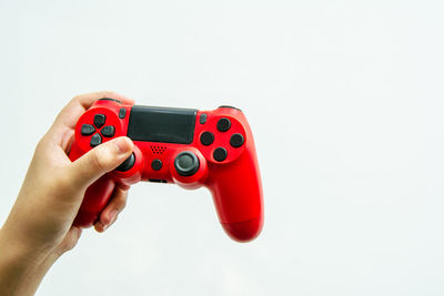 Close-up of person holding camera over white background