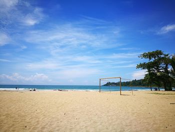 Scenic view of beach against blue sky