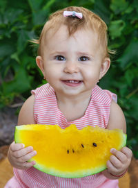 Portrait of cute girl holding yellow flower