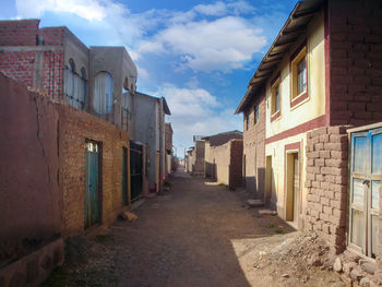 Empty alley amidst buildings in town