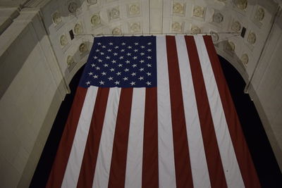 Low angle view of american flag hanging from arch