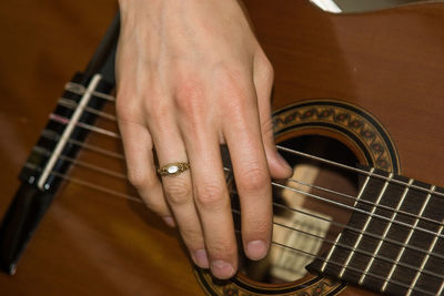 Cropped image of woman playing acoustic guitar