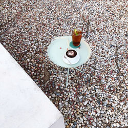 High angle view of drink and pebbles on sand