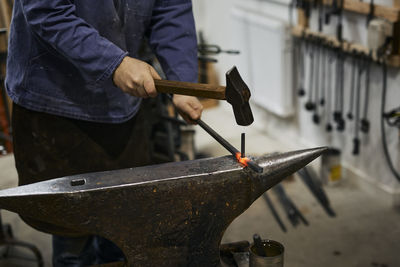 Blacksmith working in his workshop