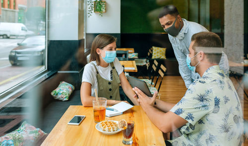 Business people at an informal business meeting in a cafe