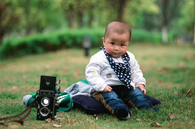 Cute boy sitting in park