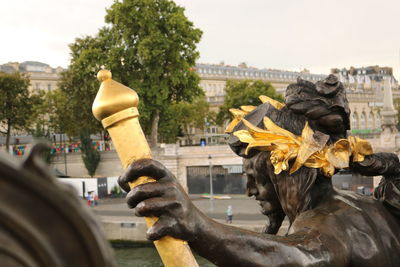 Close-up of statue against sky in city
