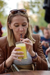 Mid section of a woman drinking glass