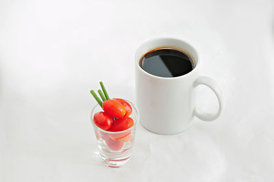 Cup of coffee on table against white background