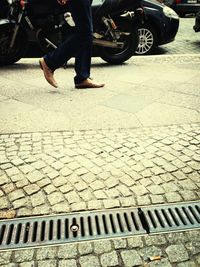 Low section of people standing on road