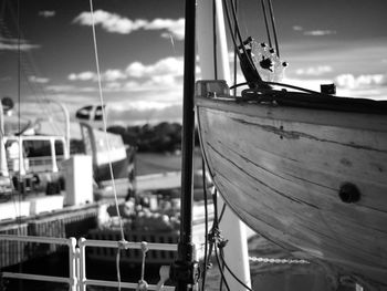 Boats moored at harbor against sky