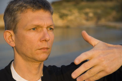 Mature man practicing tai chi at beach