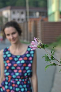 Close-up of young woman with flowers