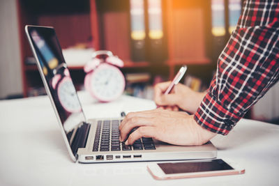 Man using laptop on table