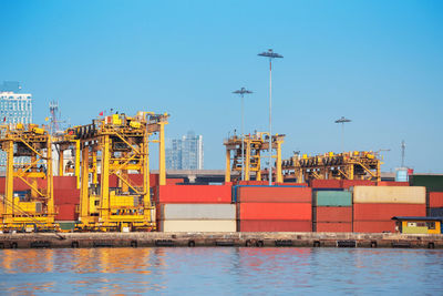 Graffiti on pier by sea against clear sky