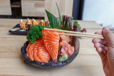 Close-up of hand holding food on table