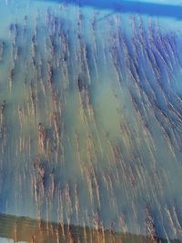 High angle view of sea water against cloudy sky