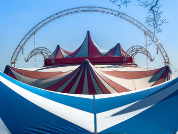 High angle view of amusement park ride against blue sky