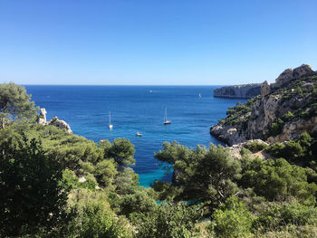 Scenic view of sea against clear blue sky