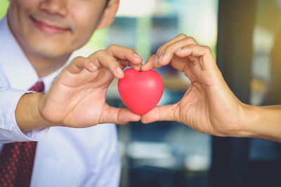 Close-up of man holding heart shape