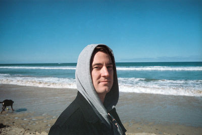 Portrait of mature man on beach against sky