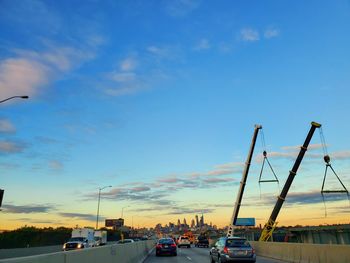 Traffic on road in city against sky