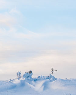 Snow covered land against sky