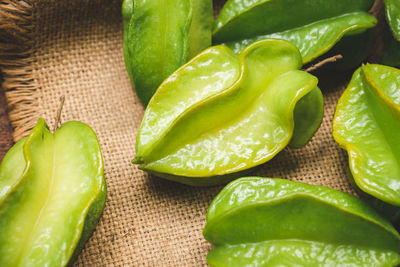 Close-up of green fruits and leaves on table