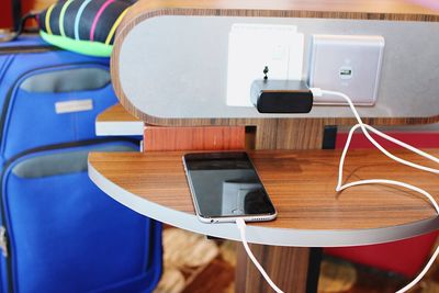 High angle view of mobile phone charging on table