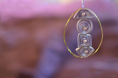 Close-up of spiral hanging on water
