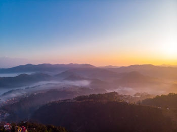 Scenic view of mountains against sky during sunrise