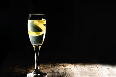 Ice cream in glass on table against black background