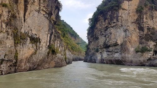 Scenic view of river amidst rock formation against sky