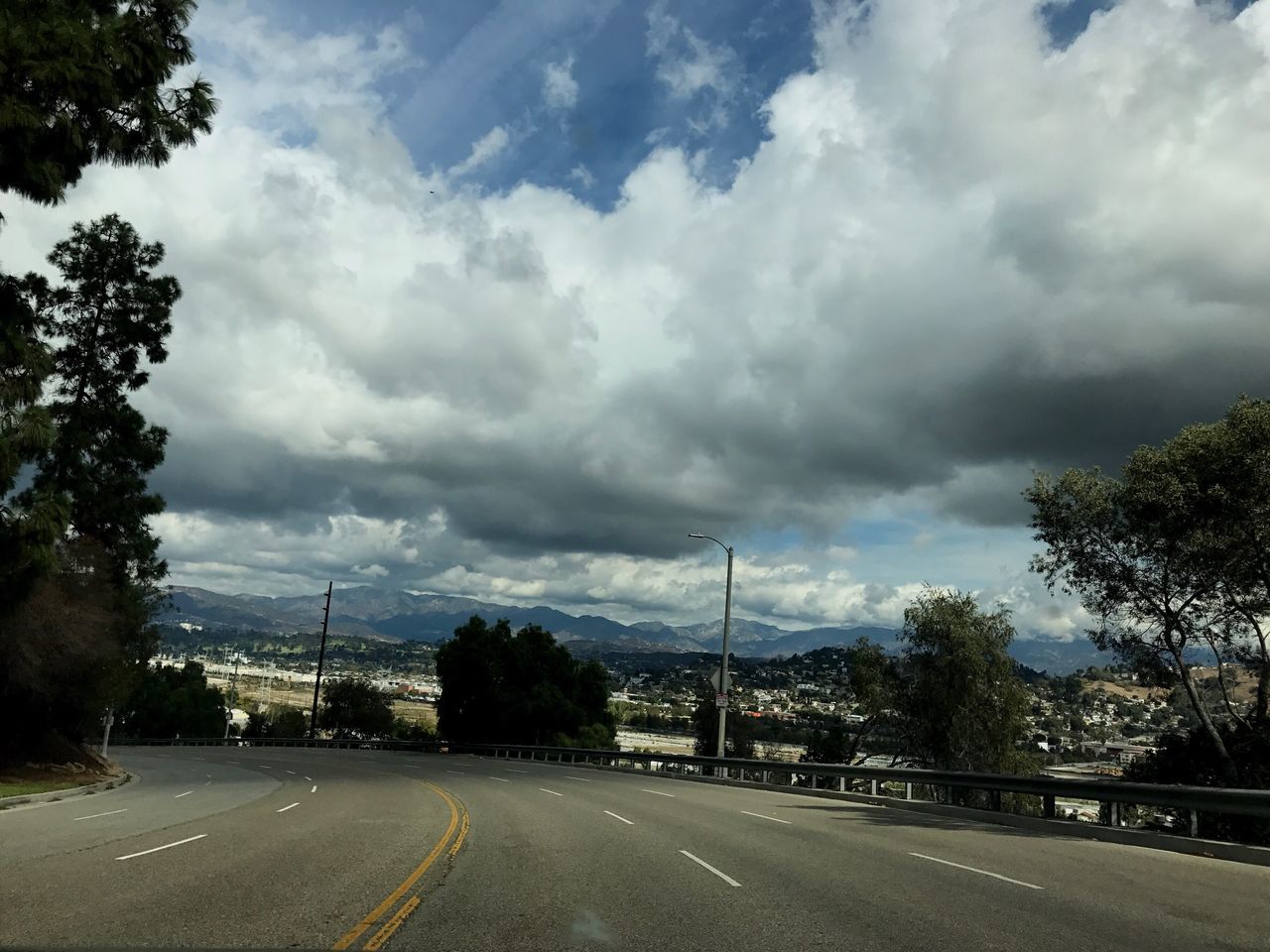 STREET AGAINST CLOUDY SKY