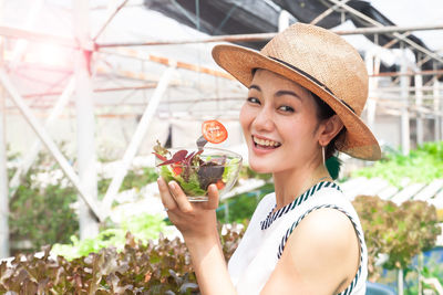 Portrait of young woman holding ice cream cone