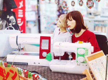 Mannequins and sewing machines at store