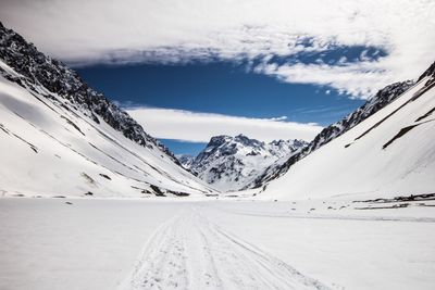 Scenic view of snow covered mountains against sky