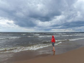 Rear view of girl standing on beach