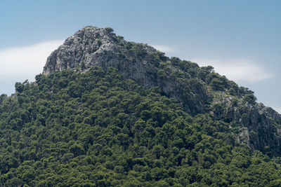 Low angle view of rock formation on mountain against sky