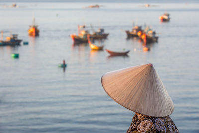 Unidentified vietnamese women overlooking fishermans bay full of fishing boats.